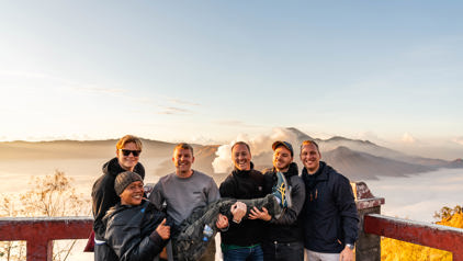 Groepsrondreis op Java: vrienden poseerden bij zonsopgang met uitzicht op de Bromo-vulkaan.